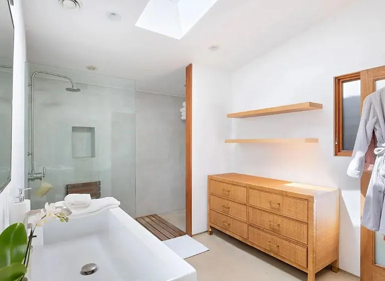 Expansive bathroom featuring an invigorating shower and abundant natural light streaming in through the skylight.