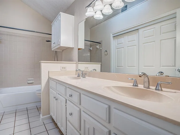 Master bath features dual sinks and large closet.