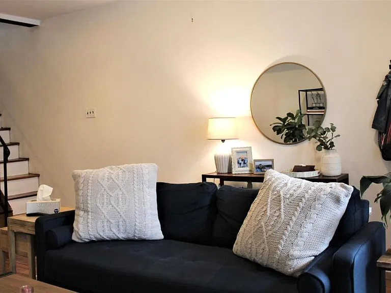 Living room showing stairs to second floor