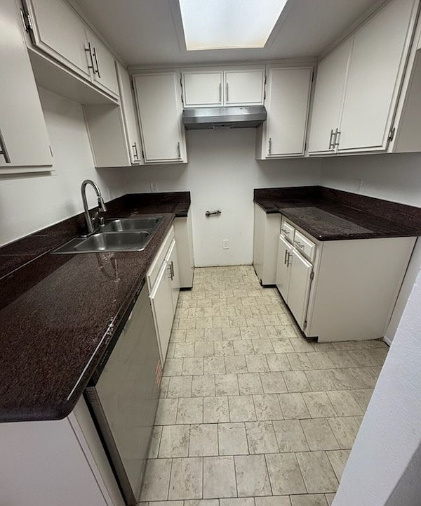 Kitchen with new Stainless Steel Dishwasher and new Stainless Steel Gas Stove (to be installed).