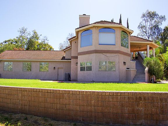 Huge West facing windows wrap around the upstairs formal living room, beautiful sunset views