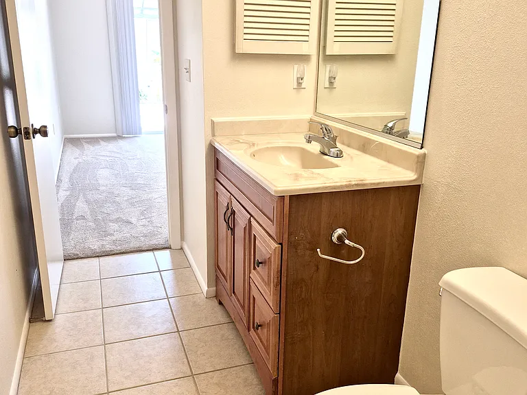 Main bathroom view of room with sliding door.
