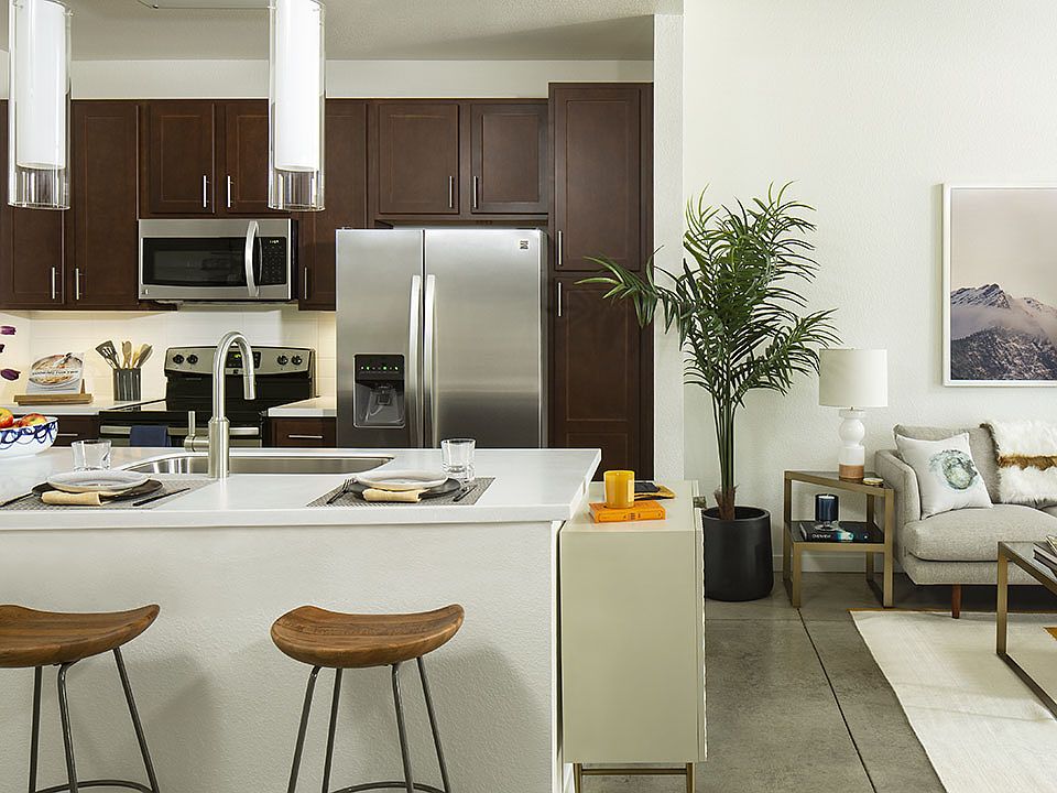 Gourmet Kitchen with Stainless Steel Appliances and Living Room with polished concrete floors..