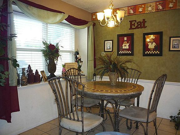 Breakfast Room Overlooks Pretty Back Yard and Deck