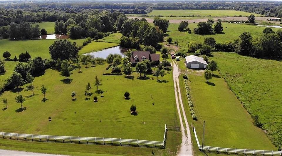 Welcome to a peaceful location with plenty of room for fruit trees, berries, stocked fishing pond, outbuilding, pasture, Koi Pond, and  beautiful story and half home.