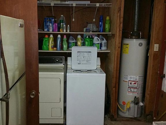 Second refrigerator along with washer/dryer in attached storage.