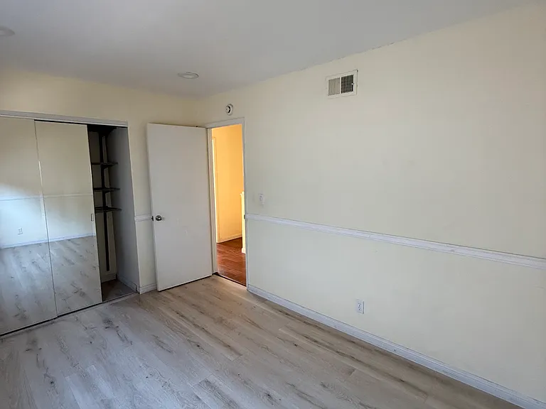 Bedroom 2 with carpets before which have now been replaced with wooden flooring
