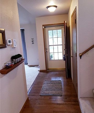 As you enter from the front you will be greeted by beautiful hard wood hall flooring, a large under the stairwell coat closet and an open concept to the living dining area.  The