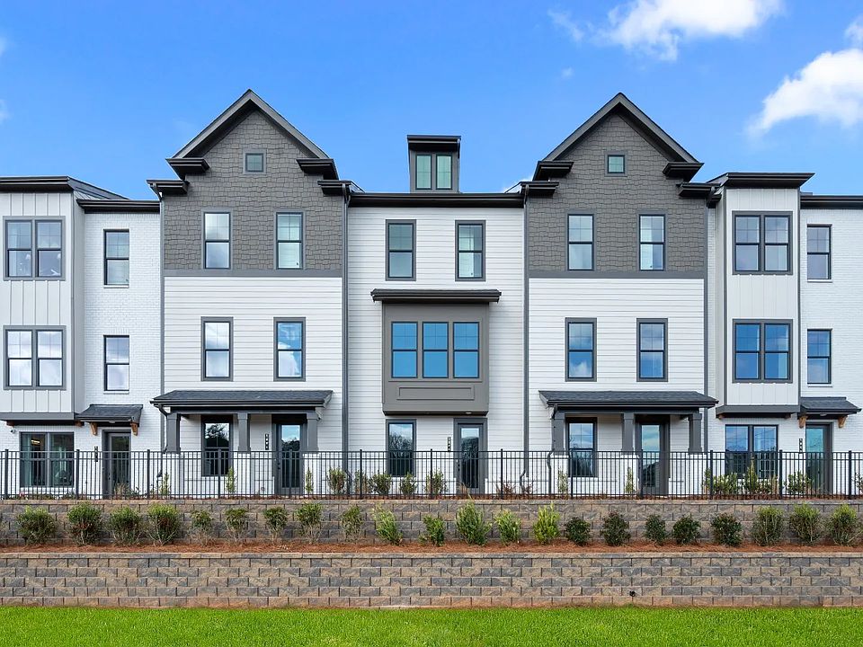 Three-story Barrett Pointe townhomes featuring contemporary design and landscaped grounds in Kennesa