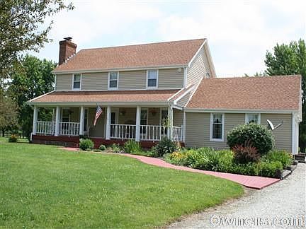Front of house with landscaping.