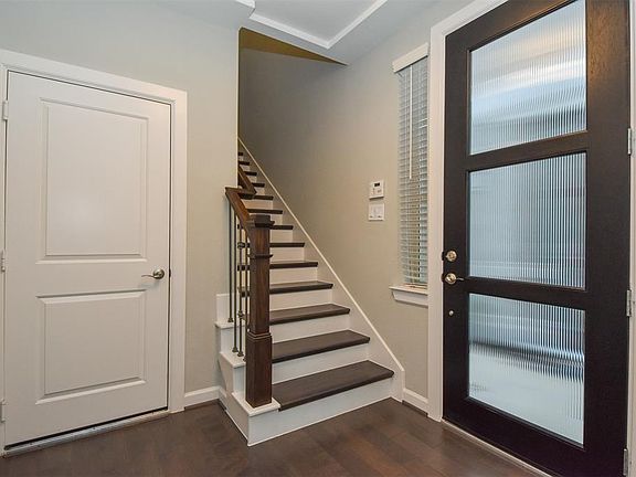 Enter through a custom rich wood and leaded glass front door onto gleaming hardwood floors offering a nice size foyer with access to the garage boasting a mud room and a full bath and bedroom on the first floor.