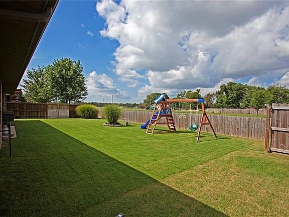 Large, level backyard with wood privacy fence. Loads of privacy and views for miles.