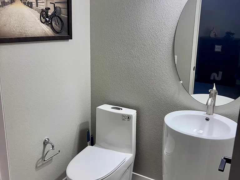 Convenient half bath located right off the kitchen on the 3rd floor