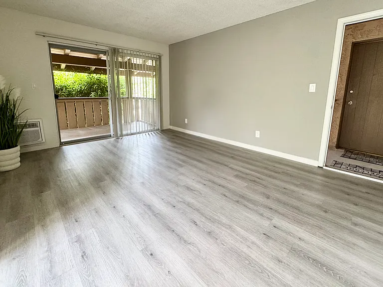 Living room overseeing the balcony and entrance door being wide open