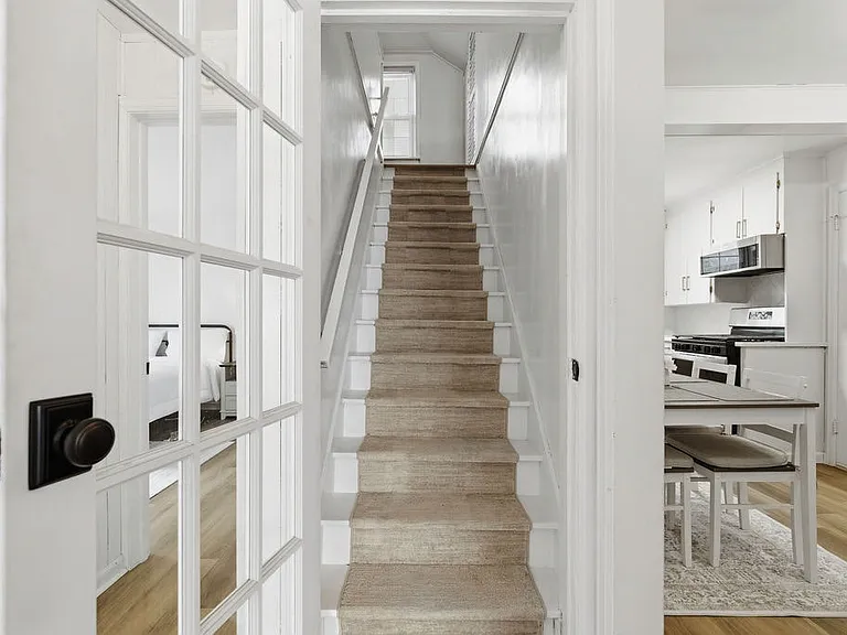Stairs lead you to the third bedroom.