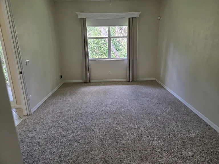 Master bedroom with new carpet and separate his and her walk-in closets