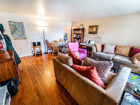 Living room with kitchen opening in far corner