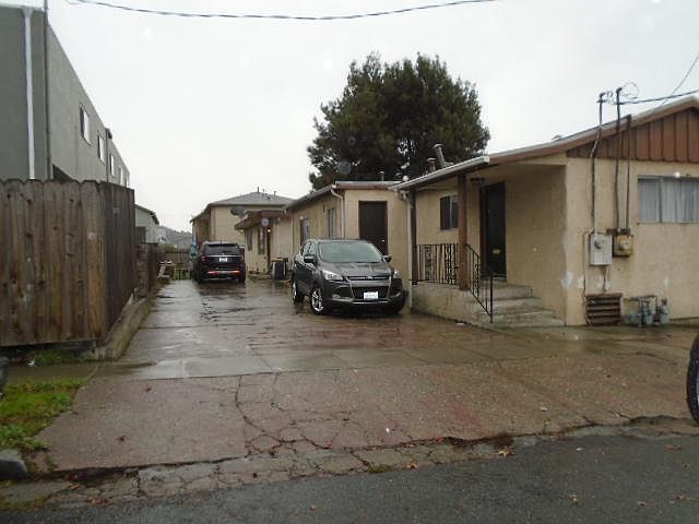 Driveway and parking near side of dwelling in back