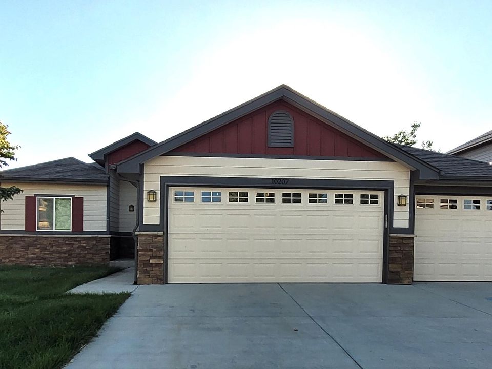 HUGE wide & deep 3 car heated/drywalled garage with dog door entry too!