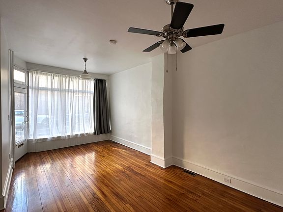 Living room with old storefront window. Room is 20'4" x 11'5".