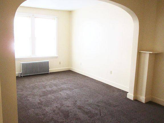 Standing in Hallway Looking Past Dining Room and Toward Living Room