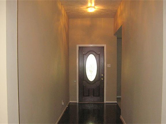 Front Door/ Hall way showing wood floor with high ceiling