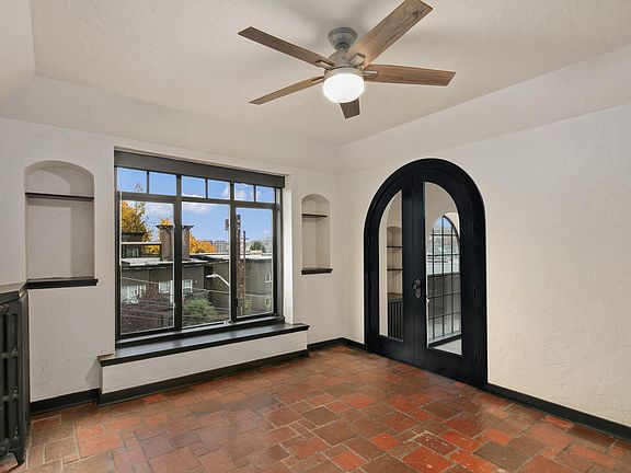 Spacious second bedroom, with new large ceiling fan, large walk in closet, southwestern views of South Lake Union, Olympic Mountains, and sunsets. There is a second door leading to the breakfast room, kitchen, and private exterior entry.
