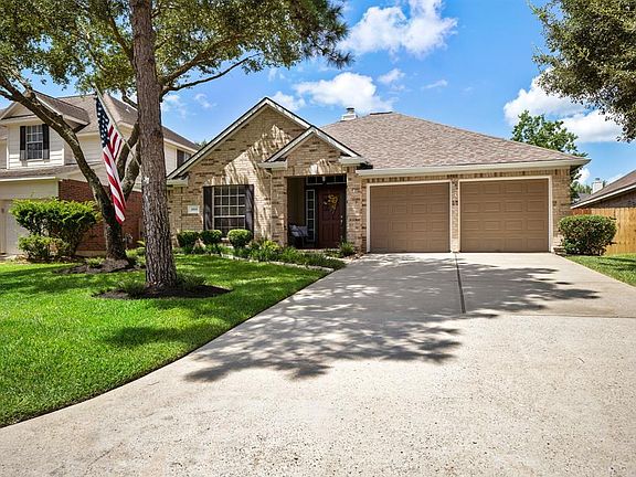 At the end of the double wide driveway the focus is the dark neutral garage doors that compliment the neutral brick of the home. Updates in the garage include new Liftmaster belt driven openers & rollers for BOTH garage doors!