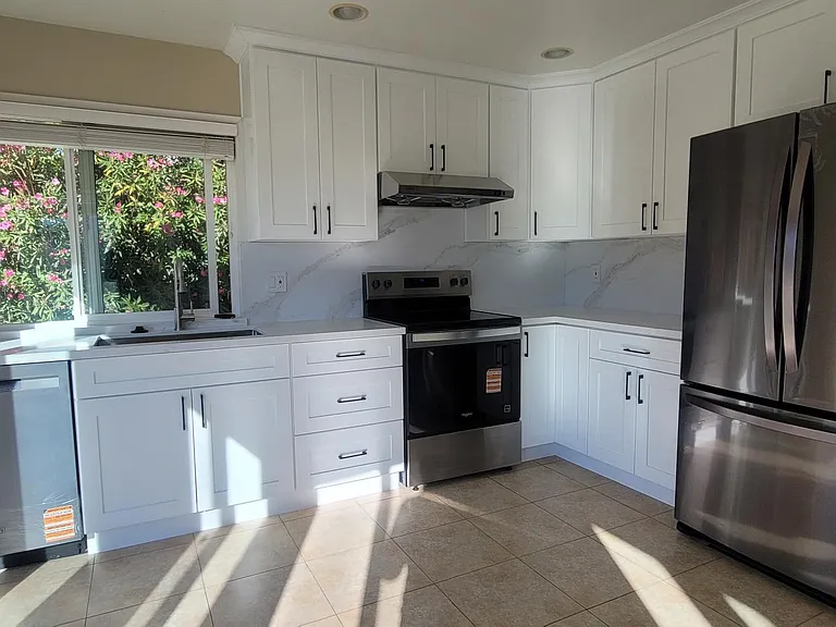 Recently remodeled kitchen with quartz countertops and brand-new stainless steel appliances.