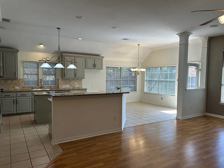 Another view of the kitchen, breakfast bar and island.
