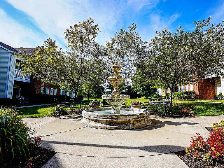 Mature trees, winding sidewalks, and a calming fountain create a courtyard that feels like a hidden garden _ right in the heart of Carmel.