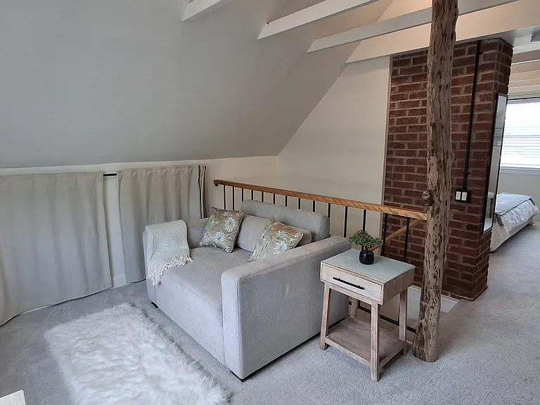 Upstairs loft for reading or just relaxing. Chair converts into a full-size bed for guests