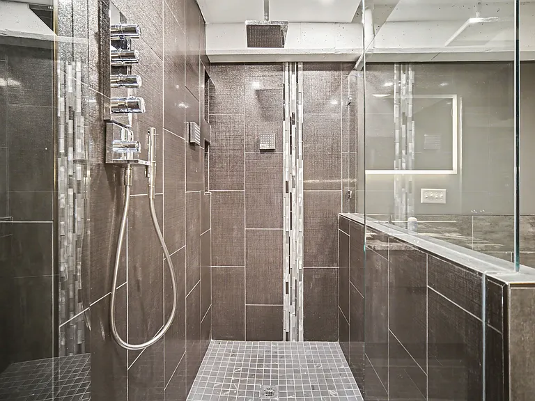 Master bathrooms features soak in bathtub with jets, massive shower with rain head and 2 additional wall shower heads and handheld shower head, backlit mirror, towel warmer, and bidet