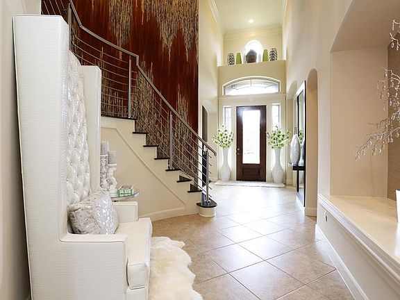 Dramatic entry with art niche and ledge for decorating.