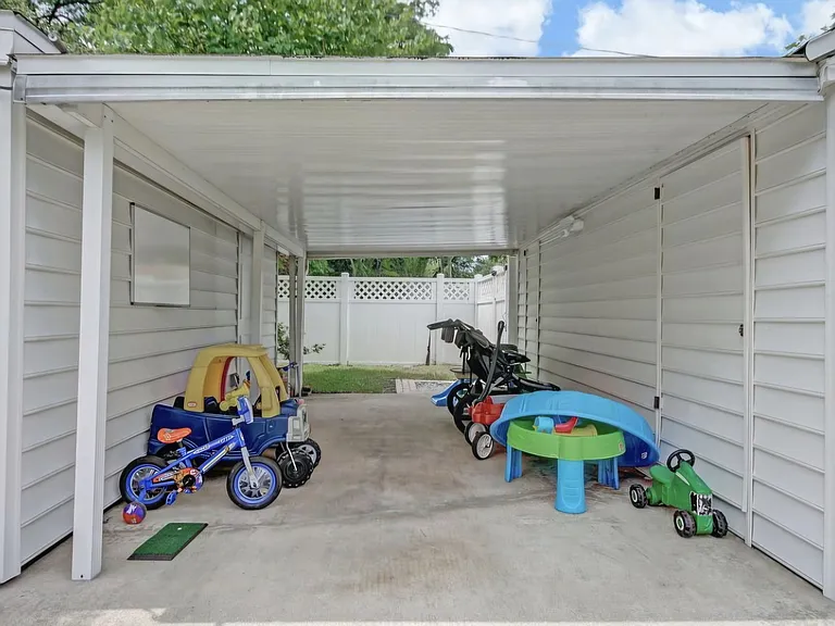 Backyard overhang. To the right there is additional storage space and to the left is the storage shed with electricity.
