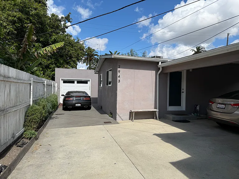 Parking in the driveway on the side of house. Garage storage is for front house