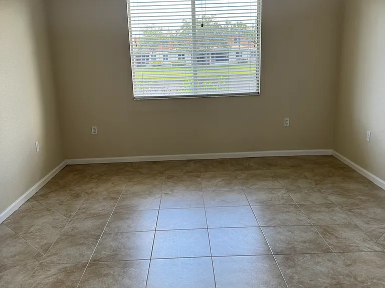 Large master bedroom with overhead fan faces the lovely lake at the back of the townhome.