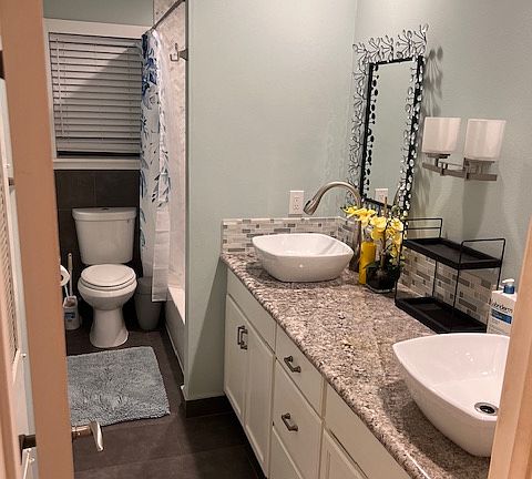 Lovely bathroom with double sink and shower.