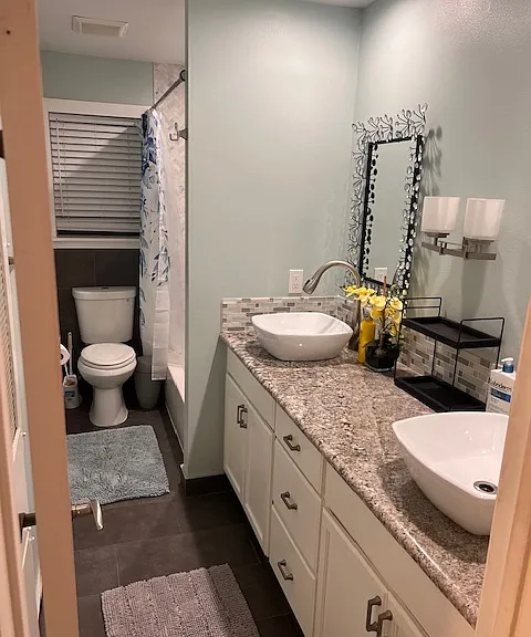 Lovely bathroom with double sink and shower.