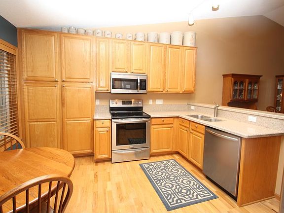 Hardwoods carry into kitchen with quartz counters, new stainless appliances and extended-height cabinetry. Large double paned kitchen window lets in wonderful natural light as well.