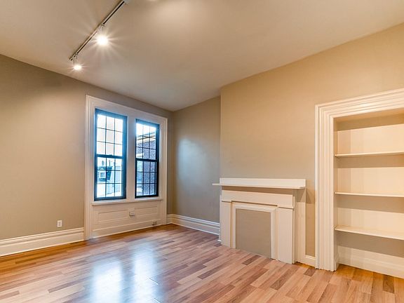 living room with a built-in bookcase and large windows