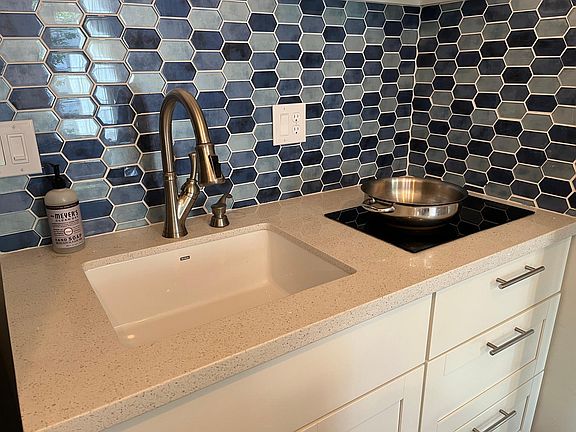 New 2-burner induction cooktop, garbage disposal, quartz counter, new cabinets, new kitchen fixtures.