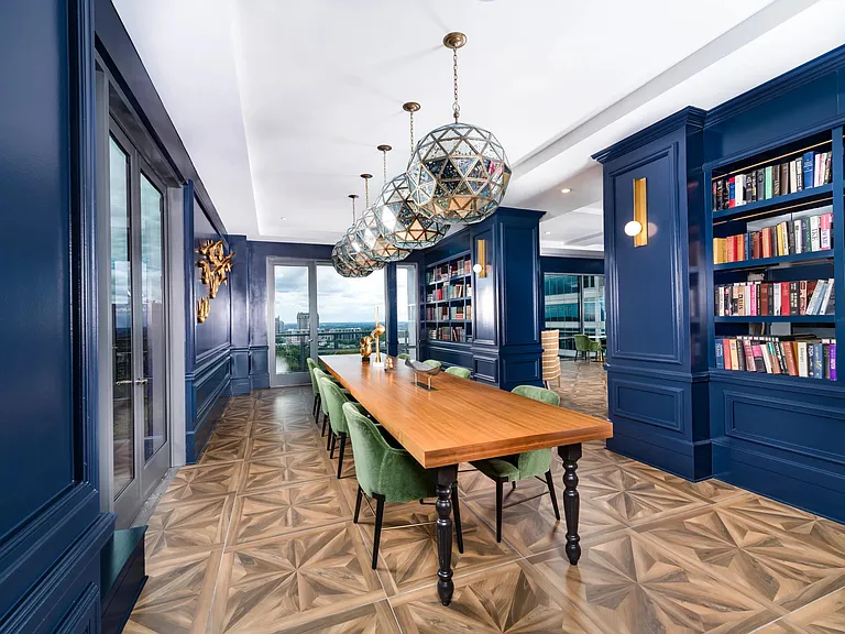 Gather in the library lounge at Modera Old Ivy, where rich design and skyline views set the scene.