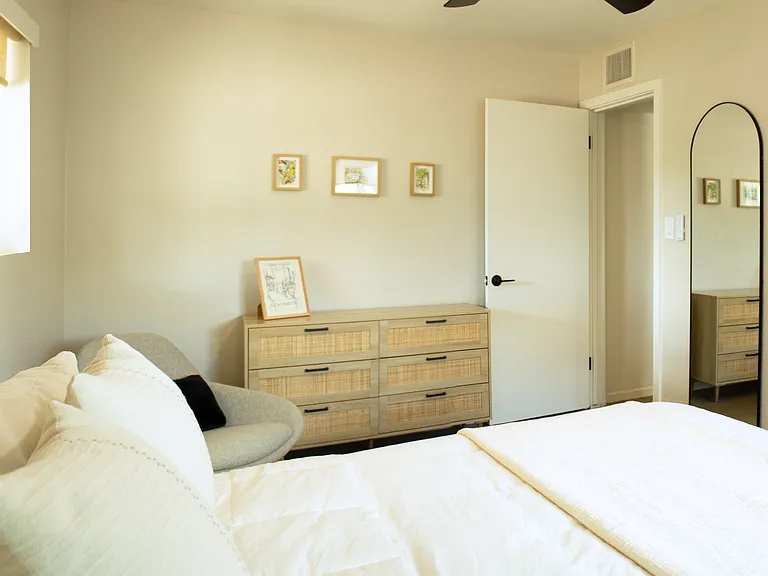 Bright, comfortable bedroom with warm finishes, ample storage, and a calm, modern feel.
