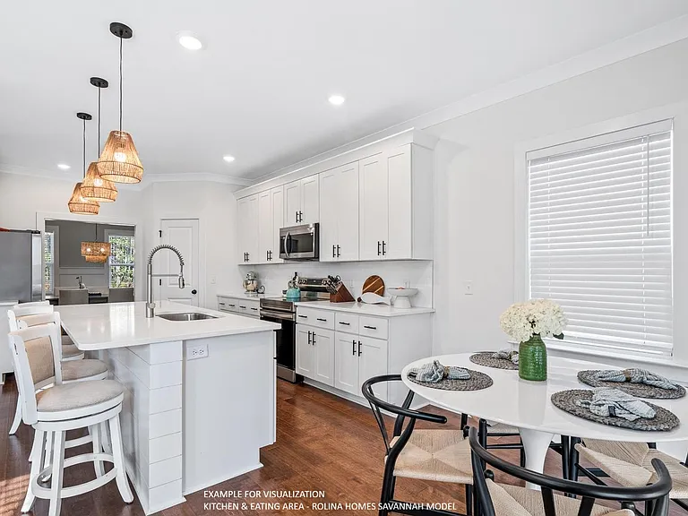 KITCHEN & EATING AREA PICTURE FROM A DIFFERENT SAVANNAH MODEL RECENTLY BUILT BY ROLINA HOMES
