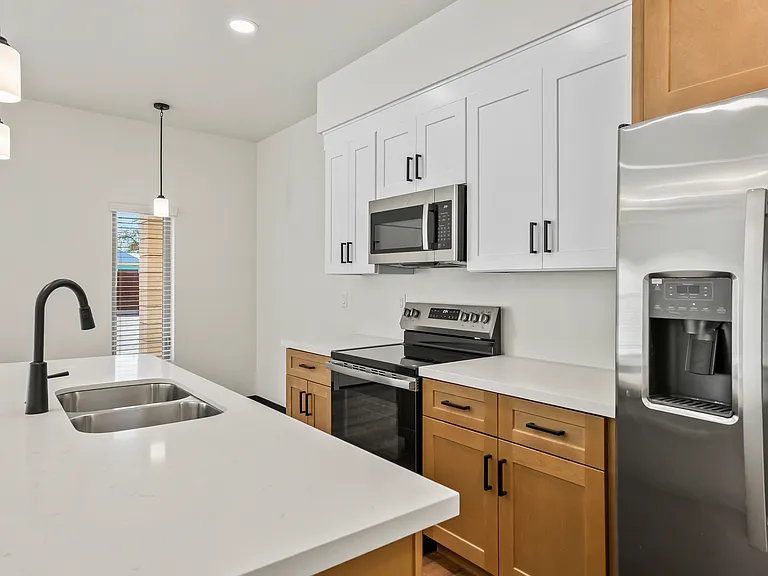 Two tone cabinets with stainless steel fingerprintless appliances.