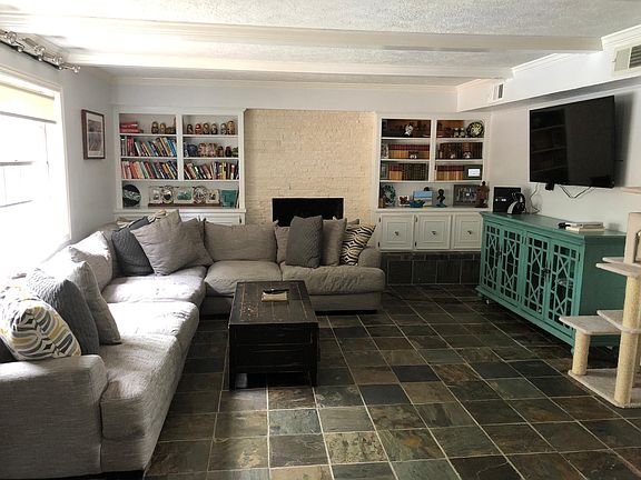 Family room with gorgeous slate floors and built-in cabinets