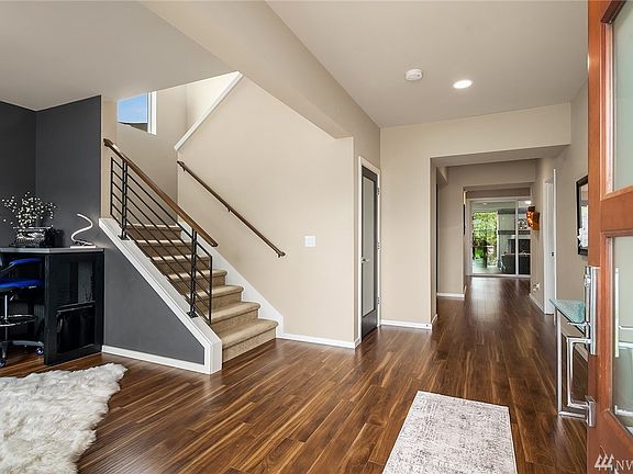 Welcome home! Expansive entry, modern railing, designer interior paint colors & extensive engineered hardwoods t/o main level. N