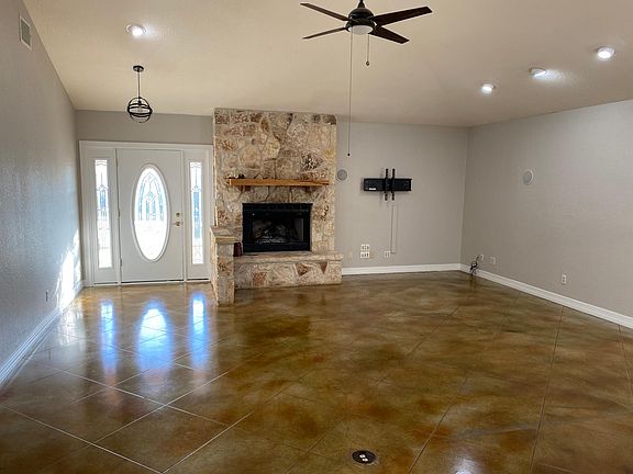 Great room with front door and fireplace