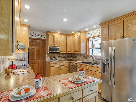 Cooking is enjoyable in the updated kitchen; complete with stainless appliances, garden window & full tile backsplash. 